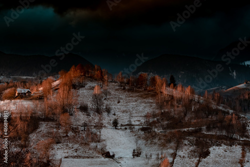 Idylic sunset light over Bucegi Mountains, Romania. Fundata village landscape