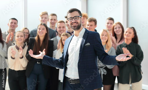 Manager and a group of diverse employees standing in the new office