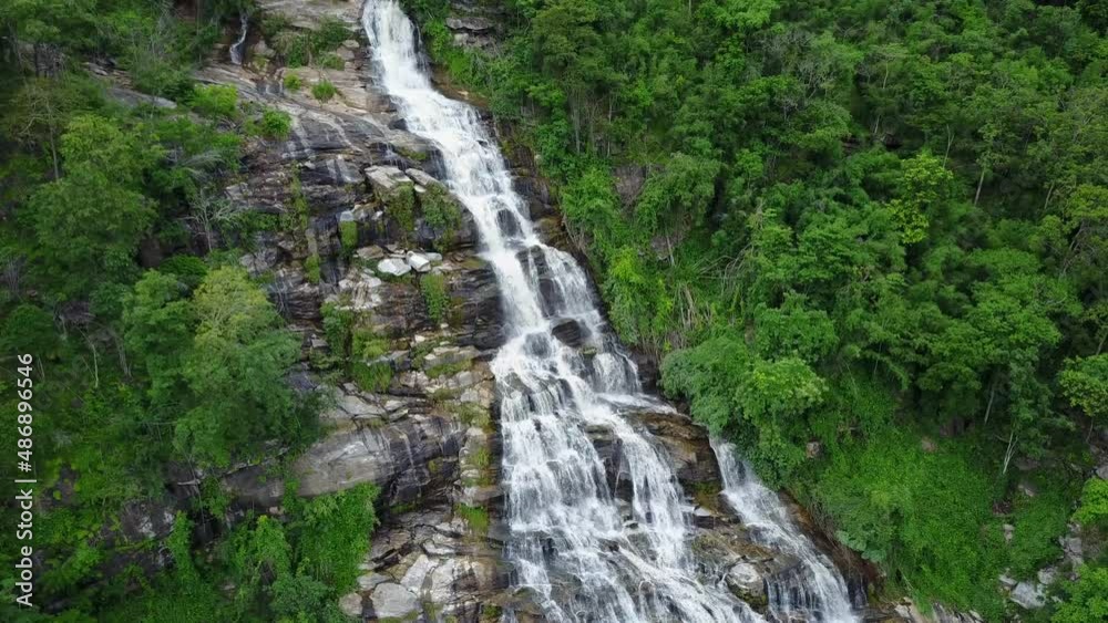 Aerial view from drone of Mae Ya Waterfalls, beautiful waterfall flowing from high cliff around with green forest background, Doi Inthanon National Park, Chiang Mai, northern Thailand. Aerial view from drone of Mae Ya Waterfalls, beautiful waterfall flowing from high cliff around with green forest background, Doi Inthanon National Park, Chiang Mai, northern Thailand.