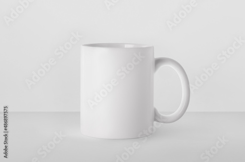 Blank ceramic mug on white background. Mockup for design