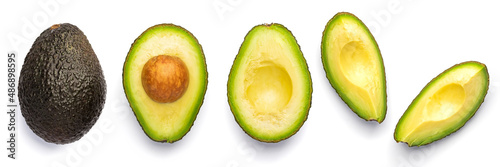 Whole and cut black Avocado Hass isolated on white background.