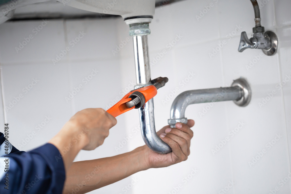 plumber at work in a bathroom, plumbing repair service, assemble and install concept. plumber at work in a bathroom, plumbing repair service, assemble and install concept.