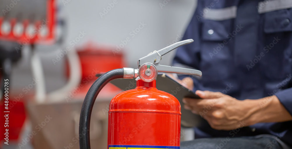 Engineer are checking and inspection a fire extinguishers tank in the fire control room for safety training and fire prevention.