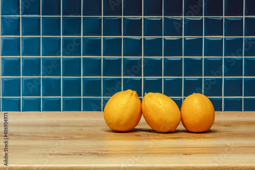 three yellow lemons in the kitchen