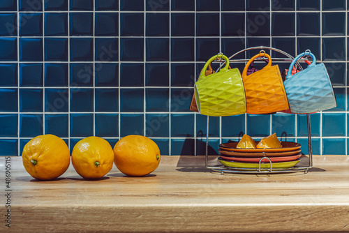 three yellow lemons in the kitchen and a tea set