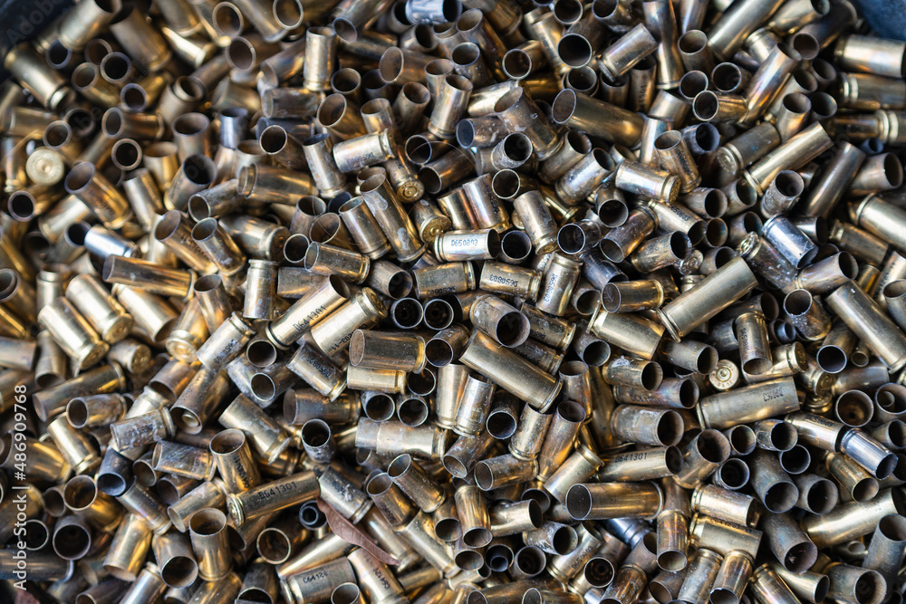 Bunch of empty pistol shells as a background. Pile of used pistol cartridges. Bunch of empty pistol shells as a background. Pile of used pistol cartridges.