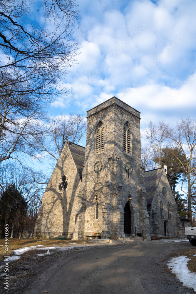 Garrison, NY - USA - Feb 10, 2022 Vertical view of the historic St Philip's Church in the Highlands, A stone Gothic Revival building designed by Richard Upjohn and opened in 1865. Garrison, NY - USA - Feb 10, 2022 Vertical view of the historic St Philip's Church in the Highlands, A stone Gothic Revival building designed by Richard Upjohn and opened in 1865.