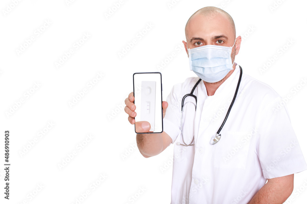 Middle-aged doctor in white robe with stethoscope around his neck on a white background holding a phone with a positive test Middle-aged doctor in white robe with stethoscope around his neck on a white background holding a phone with a positive test