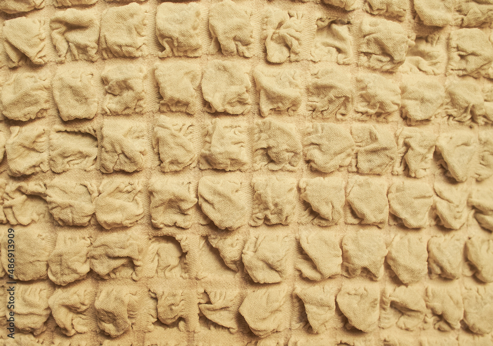 Fabric pattern background of a brown beige Waffle Towel like embossed texture seamless patterned.