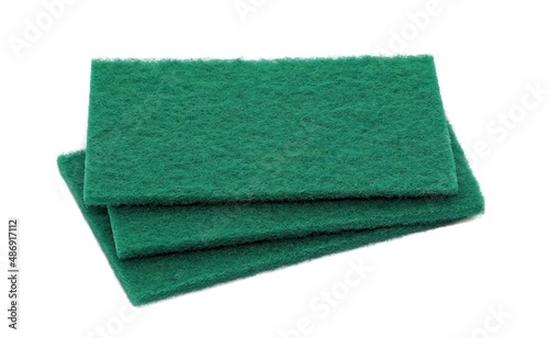A small stack of green scouring cleaning sponge pads isolated on a white background