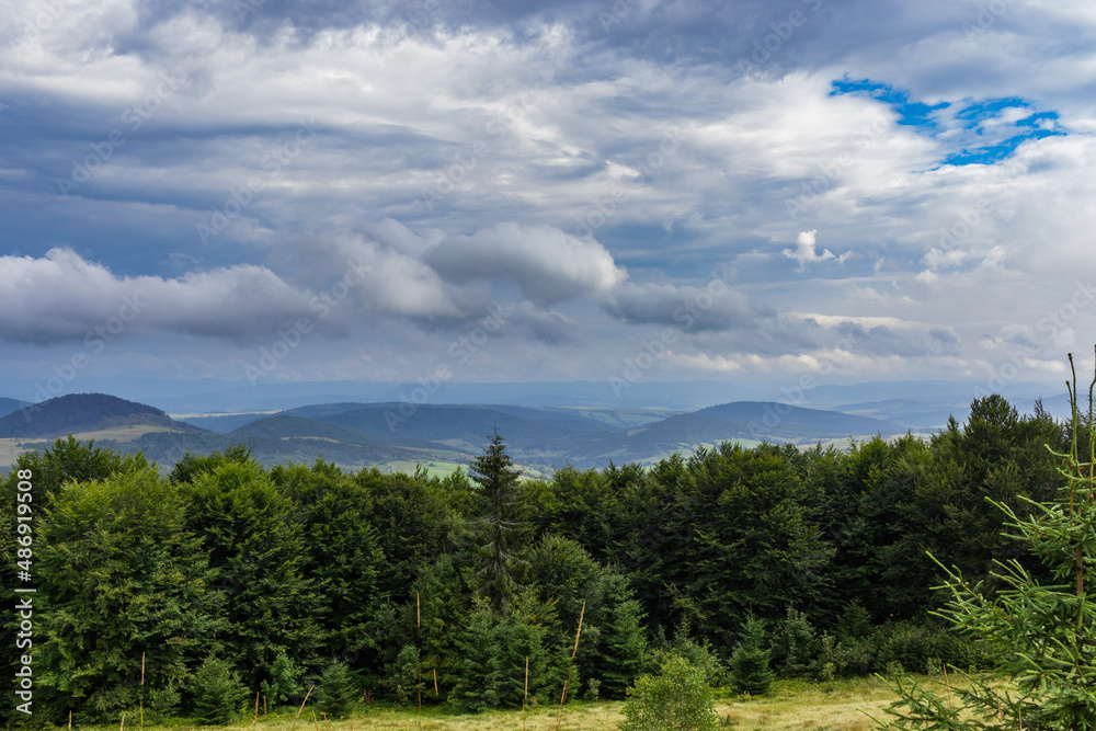 Amazing landscape at the mountain top. Panoramic view at mountain valleys lit by sun. Carpathians landscape, Ukraine