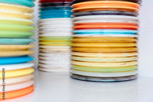stack of colorful discs and frisbees