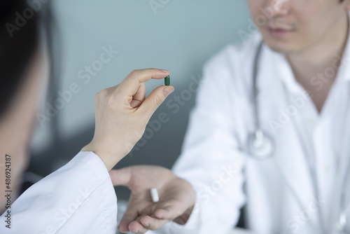 Close up of doctor holding pills