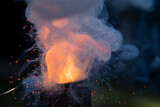 Flame explosion of Cracker gunpowder in a spoon with a lot of smoke bubbling and pushing upward