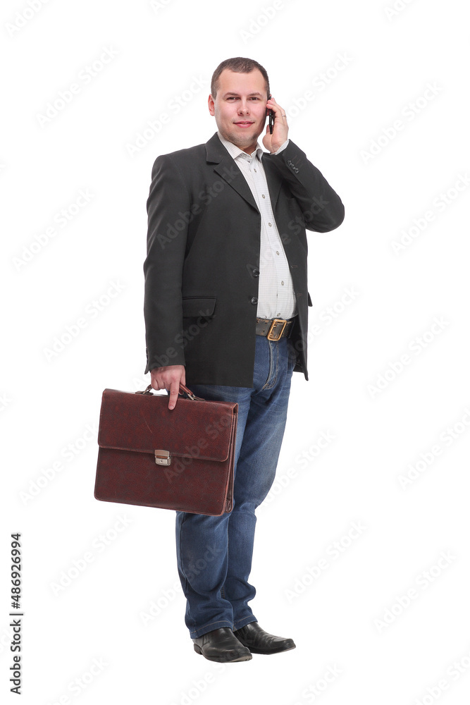 Business man holding a briefcase and speaking on the phone while smiling Business man holding a briefcase and speaking on the phone while smiling