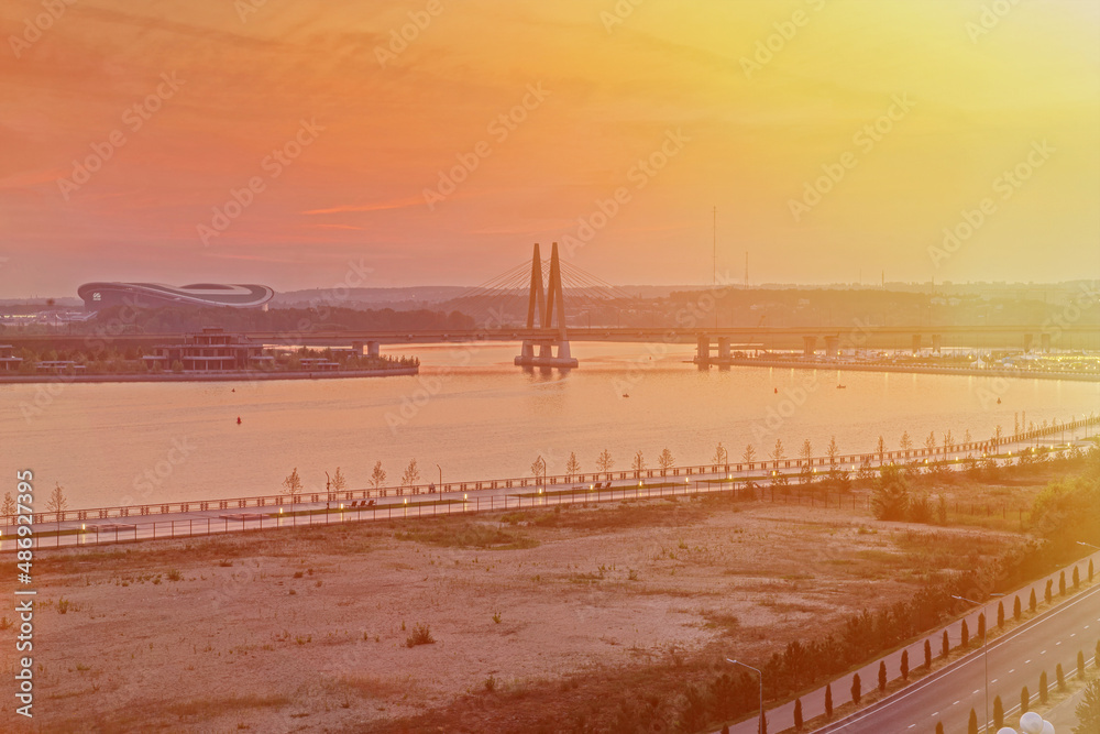 Millennium Bridge in Kazan, Russia. Cable-stayed bridge across the river. View from the Kremlin embankment. Beautiful city view at dawn. Panoramic view 