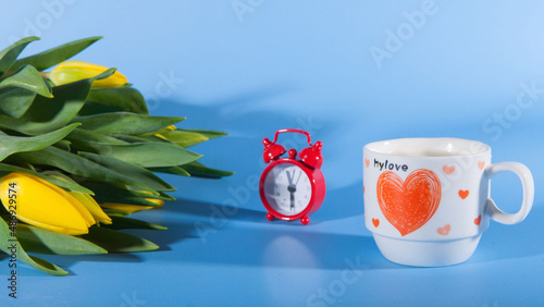 Flowers, coffee and red clocks. Romance on Valentine's Day