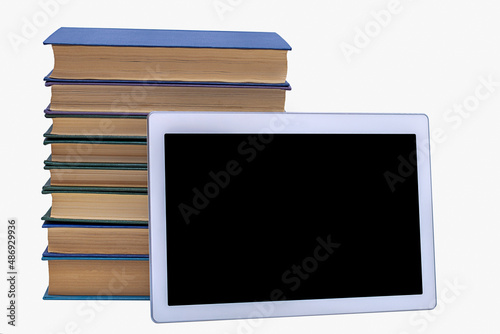 A stack of books and a computer tablet in a horizontal position, isolated on a white background.