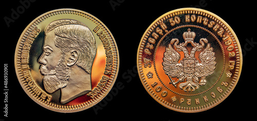 The rare gold coin with double denomination for Russian and French currency on the dark background. Translation: 37 roubles 50 kopeks 1902, 100 franks * Nicolas II Emperor photo