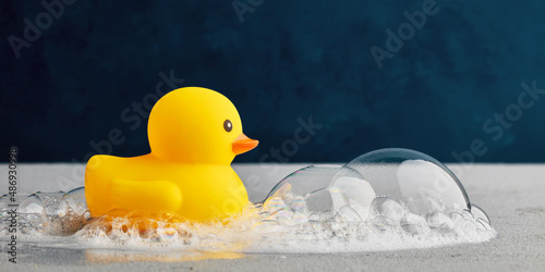 Obraz na płótnie Yellow rubber duck toy with soap or shampoo bubble foam in the bathroom