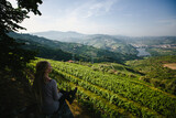 A young woman looks out over the Douro Valley from the hill, Porto, Portugal.