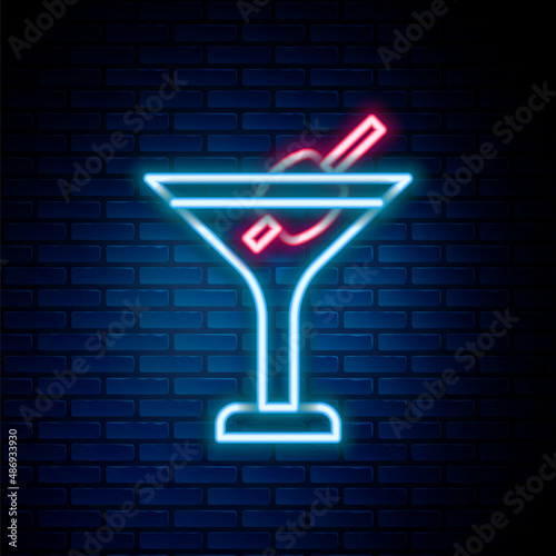 Glowing neon line Martini glass icon isolated on brick wall background. Cocktail icon. Wine glass icon. Colorful outline concept. Vector