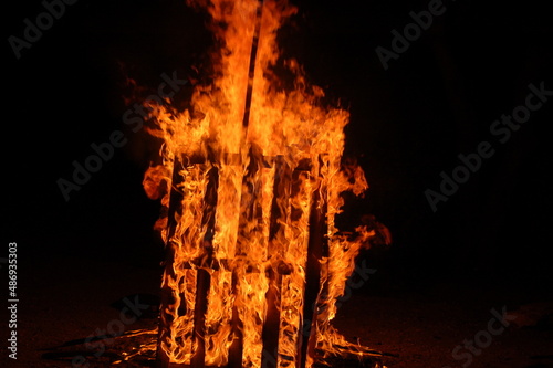 Bonfire with burning boards, large, at night in the dark. For Lag Omer