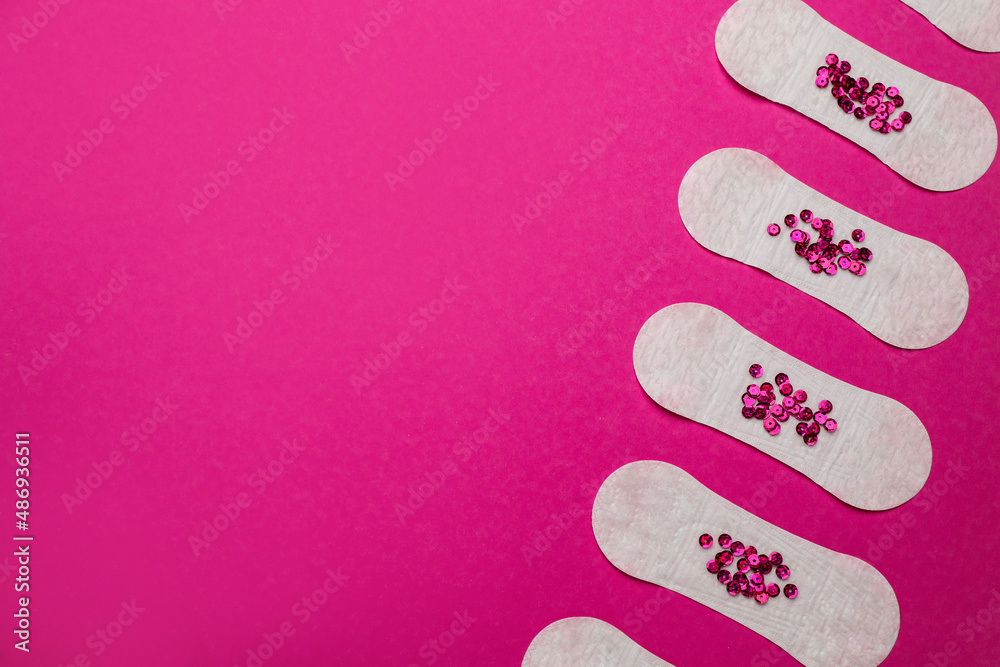 Sanitary pads with sequins on pink background, flat lay and space for text. Menstrual cycle Sanitary pads with sequins on pink background, flat lay and space for text. Menstrual cycle