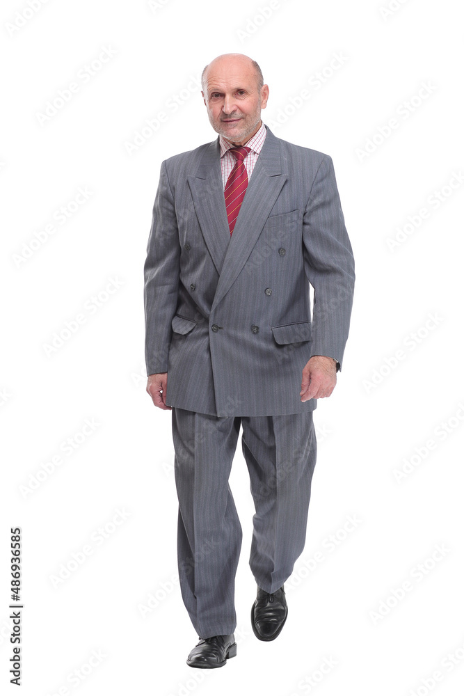 full length picture of a senior business man walking towards the camera and smiling. full length picture of a senior business man walking towards the camera and smiling.