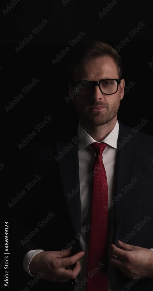 young businessman walking in with his hands in pockets, closing his suit, smiling then leaving young businessman walking in with his hands in pockets, closing his suit, smiling then leaving