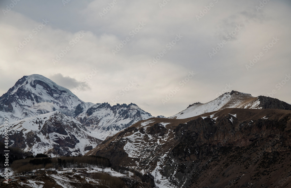 High snow covered mountain Kazbek at the sunrise.  Winter mountains landscape. Georgia,  Kazbegi.