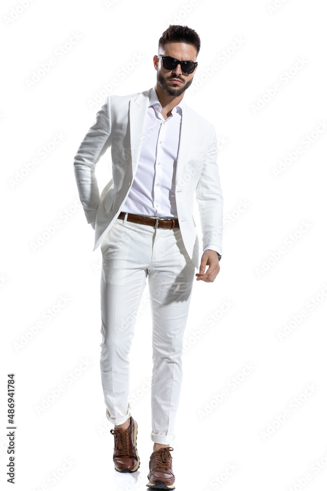 cool businessman in white suit with eyeglasses holding hand in pocket cool businessman in white suit with eyeglasses holding hand in pocket