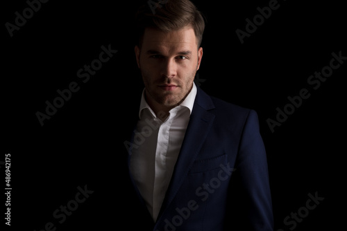 portrait of handsome businessman in suit smiling and posing