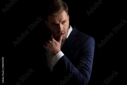 Tableau sur toile seductive young man in suit holding finger to lips and being sexy