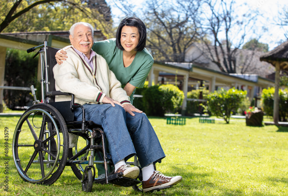 Caucasian senior on the wheelchair smiling with nurse outdoor. Retired elderly people living their life at its best. Caucasian senior on the wheelchair smiling with nurse outdoor. Retired elderly people living their life at its best.
