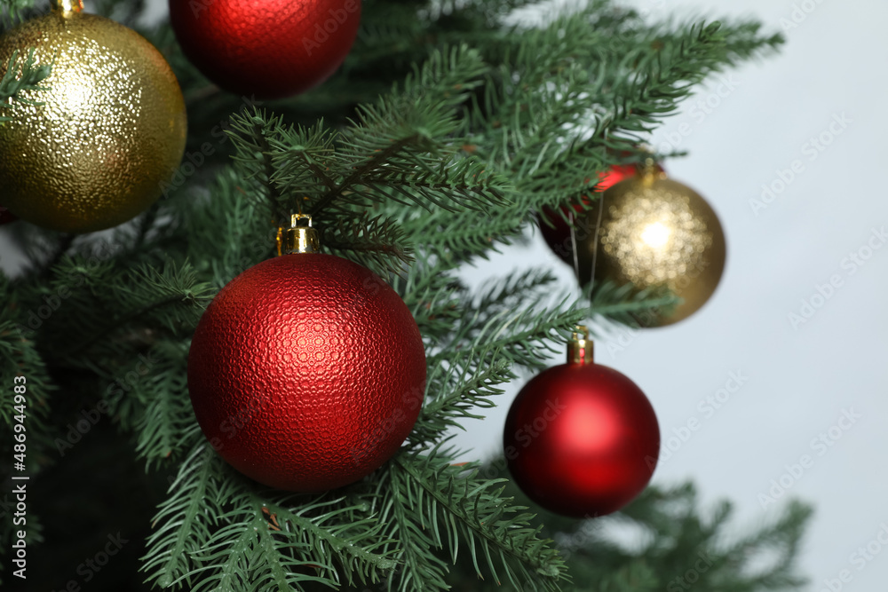 Beautiful Christmas tree with shiny baubles on white background, closeup Beautiful Christmas tree with shiny baubles on white background, closeup