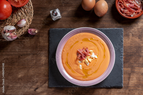 Salmorejo dish with ham and egg, along with the ingredients used for its preparation. photo