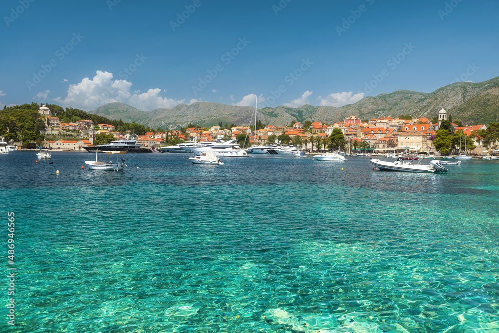 Turquoise water of Adriatic sea in Cavtat town, Dalmatia, Croatia. Touristic resort with yachts and boats.