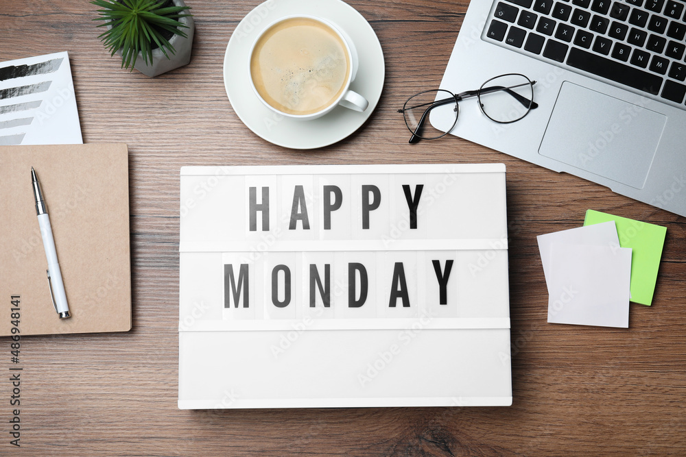 Light box with message Happy Monday, office stationery and cup of coffee on wooden desk, flat lay Light box with message Happy Monday, office stationery and cup of coffee on wooden desk, flat lay