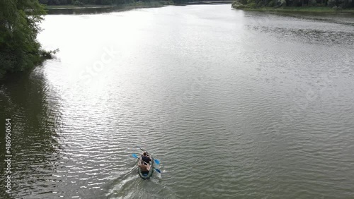 Russia, Volga, 07.08.2021. People in a boat float on the river in sunny weather, aerial video. Water recreation concept. editorial use only.