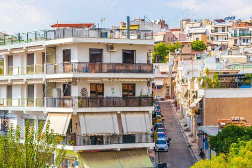 Fototapeta Naklejka Na Ścianę i Meble -  Typical street road buildings cars in Greeces capital Athens Greece.