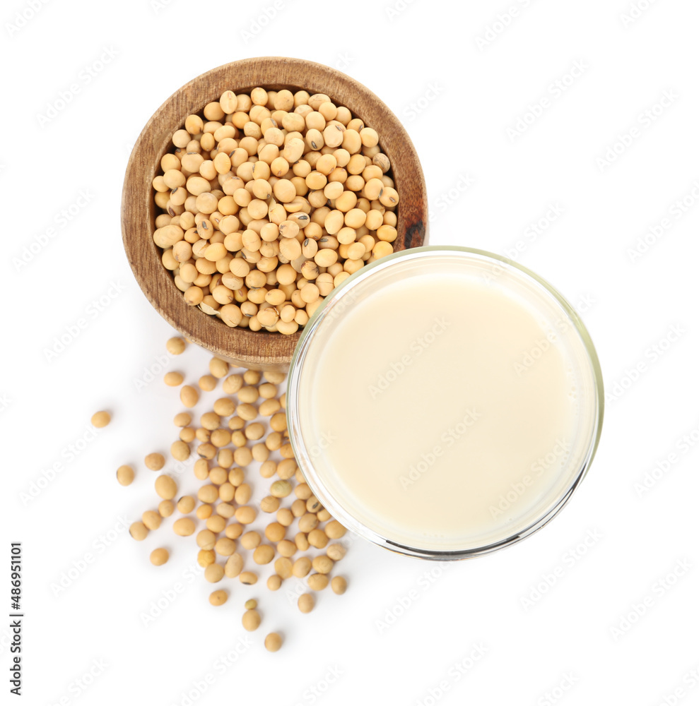 Glass of fresh soy milk and bowl with beans on white background, top view Glass of fresh soy milk and bowl with beans on white background, top view