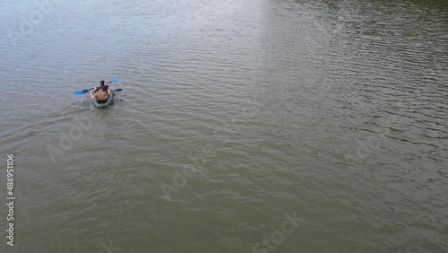Russia, Volga, 07.08.2021. People in a boat float on the river in sunny weather, aerial video. Water recreation concept. editorial use only.