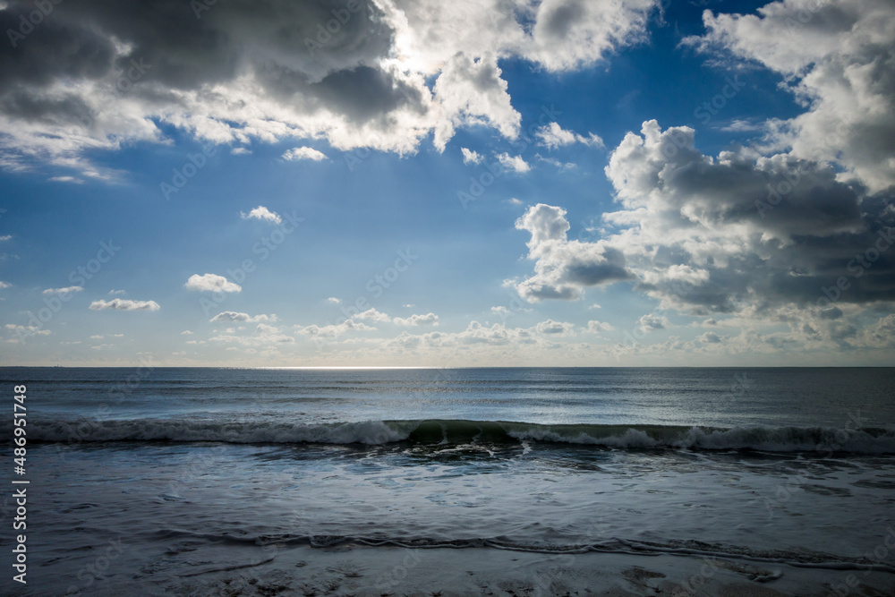 Cloudy seascape view from a beach at sunset