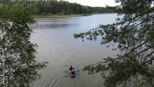 Russia, Volga, 07.08.2021. People in a boat float on the river in sunny weather, aerial video. Water recreation concept. editorial use only.