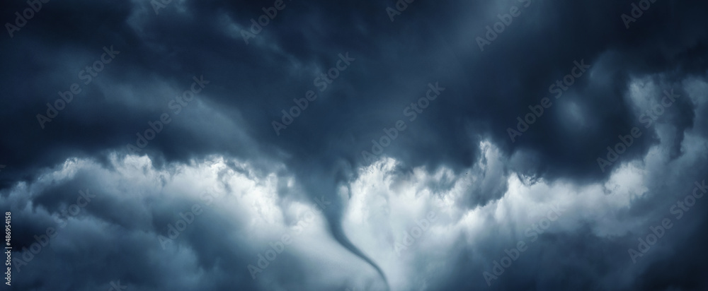 The typhoon is born, a tornado in a stormy dark sky with black clouds and a strong wind. Concept on the theme of weather, natural disasters, tornadoes, typhoons, tornadoes, thunderstorm.
