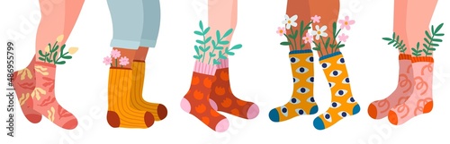 Womens legs in socks. Different cotton patterned products with spring flowers. Fashionable colors wear. Feet in casual stockings with leaves and blossoms. Vector clothing elements set