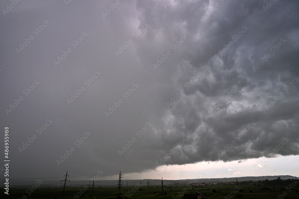 Landscape of dark ominous clouds forming on stormy sky during heavy thunderstorm Landscape of dark ominous clouds forming on stormy sky during heavy thunderstorm