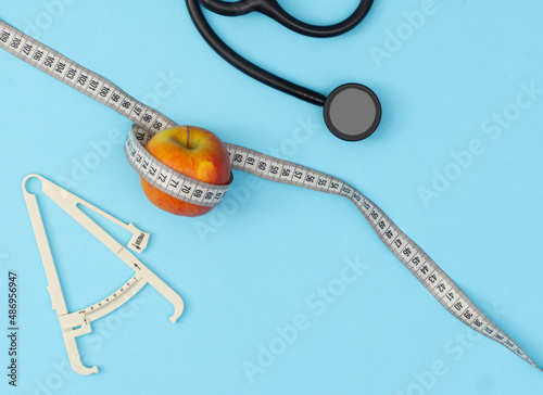 Healthy concept. Health check with caliper, stethoscope, apple, measuring tape