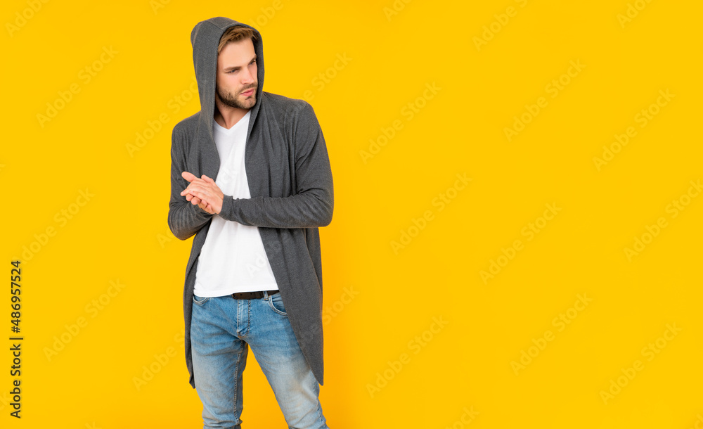 bearded young man in hood on yellow background with copy space, casual bearded young man in hood on yellow background with copy space, casual